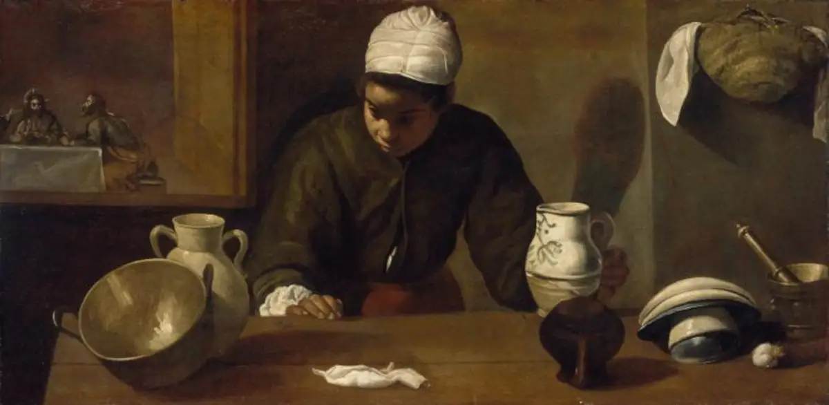Donna in cucina con Cena di Emmaus